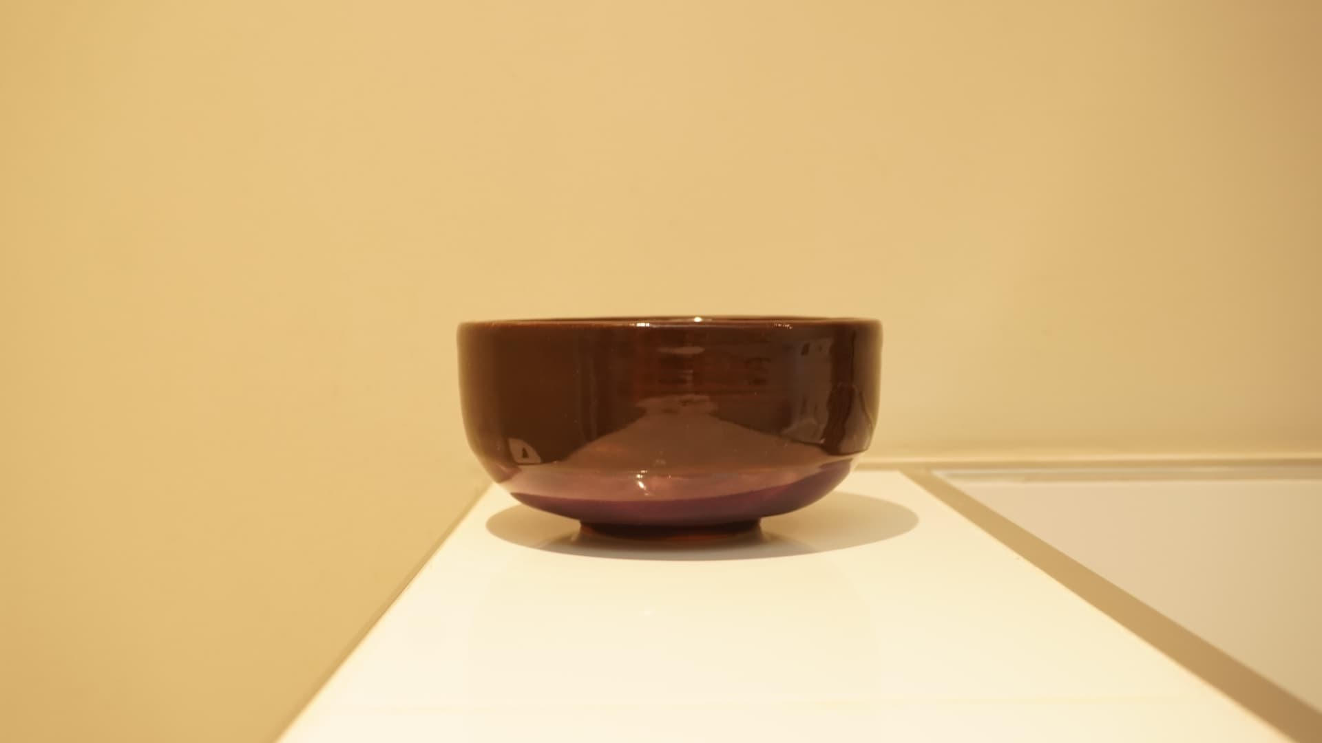Plum & Petal Bowl · Wheel-thrown · Spectrum 1134 Chocolate + Mayco FN234 Royal Purple, PC602 White Cascade (petal detailing inside) — Ceramic work by RuiXuan Xu — Club